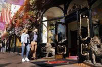a man and a woman standing in front of a store at Arlington Hotel O'Connell Bridge in Dublin