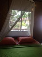 a bed in a room with a window at Malibu Beach Bungalows in Chaloklum