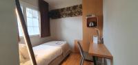 A bed or beds in a room at Aigle d&#39;Or - Strasbourg Nord