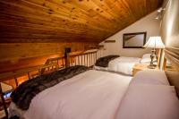 a room with two beds in a log cabin at Kandahar Lodge at Whitefish Mountain Resort in Whitefish