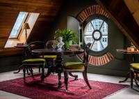 a dining room with a table and chairs on a red rug at The Rookery in London