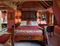 a bedroom with a large bed and a desk at The Rookery in London