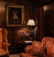 a room with a painting of a woman on a wall at The Rookery in London