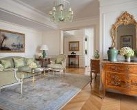 a living room with a couch and a table at Four Seasons Hotel George V Paris in Paris