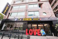 a building with a love sign in front of it at Travel Art Inn in Chiayi City
