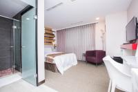 a hotel room with a bed and a glass shower at Travel Art Inn in Chiayi City