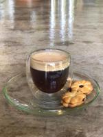 a glass cup of coffee and cookies on a plate at Wave-F in Ko Kood