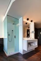 a bathroom with a glass shower and a sink at Olivia Balmes Hotel in Barcelona