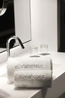 a white towel is sitting on a bathroom sink at Olivia Balmes Hotel in Barcelona