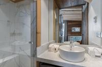 a bathroom with a sink and a shower at Penthouse Chamois - LES CHALETS COVAREL in La Daille