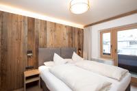 Posteľ alebo postele v izbe v ubytovaní Angerer Alpine Suiten und Familienappartements Tirol