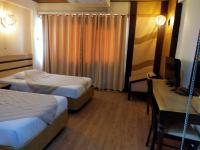 Postel nebo postele na pokoji v ubytování Nan Chao Hotel