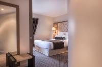 a hotel room with a bed and a mirror at La Villa des Ternes in Paris