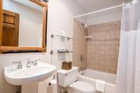 a bathroom with a sink and a toilet and a tub at Kandahar Lodge at Whitefish Mountain Resort in Whitefish