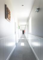a hallway of a building with white walls and white floors at B&amp;B Nieuwhof in Gistel