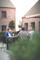 a group of people sitting at a table at B&amp;B Nieuwhof in Gistel