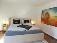A bed or beds in a room at Bergjuwel