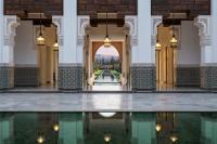 a hallway with a pool of water in a building at The Oberoi Marrakech in Marrakech