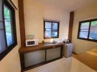 a kitchen with a sink and a microwave on a counter at Moonstone Studio in Haad Rin