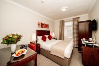 a hotel room with a large bed and a desk at White Sands Hotel in Portmarnock