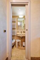 a bathroom with a tub and a sink and a mirror at Hotel Vecellio Venice on the Lagoon in Venice