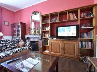 a living room with a couch and a television at Gorgeous Holiday Home in Martigny le Comte with private Pool in Martigny-le-Comte