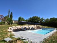 a swimming pool with umbrellas and chairs in a yard at Gorgeous Holiday Home in Martigny le Comte with private Pool in Martigny-le-Comte