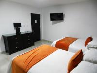 Postel nebo postele na pokoji v ubytování Hotel La Colonia
