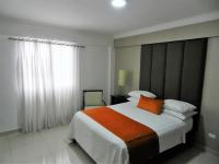 Postel nebo postele na pokoji v ubytování Hotel La Colonia