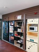 a room with a book shelf and a microwave at Mister Bed Chambray Les Tours in Chambray-lès-Tours