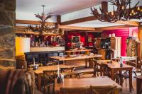 a restaurant with wooden tables and chairs and a bar at Badhotel Rockanje in Rockanje