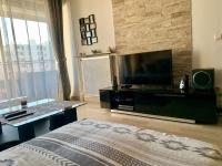 a living room with a flat screen tv and a bed at Cocoon vue Mer ☆ en face du Port de Golfe-Juan ☆ in Golfe-Juan