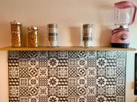 a shelf with tiles on a wall with a blender at Cocoon vue Mer ☆ en face du Port de Golfe-Juan ☆ in Golfe-Juan