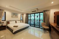 Postel nebo postele na pokoji v ubytování Nalanta Hotel Pattaya