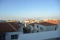 a view of a city with roofs and buildings at Yeşilyurt Residence in İzmir