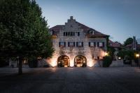 a large stone building with a sign on it at Hotel &#47; Weingut Meintzinger in Frickenhausen
