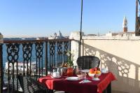 a table with a bowl of fruit on a balcony at A Tribute To Music Residenza in Venice