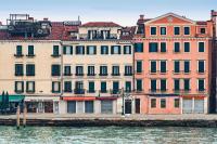 a group of buildings next to a body of water at A Tribute To Music Residenza in Venice