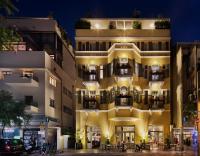 an apartment building with a lit up facade at night at Sam&amp;Blondi in Tel Aviv