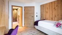 Ein Bett oder Betten in einem Zimmer der Unterkunft Boutiquehotel die Alpbacherin 4 Sterne Superior
