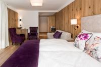Ein Bett oder Betten in einem Zimmer der Unterkunft Boutiquehotel die Alpbacherin 4 Sterne Superior