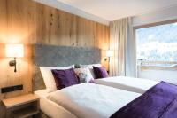 Ein Bett oder Betten in einem Zimmer der Unterkunft Boutiquehotel die Alpbacherin 4 Sterne Superior