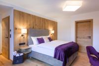 Ein Bett oder Betten in einem Zimmer der Unterkunft Boutiquehotel die Alpbacherin 4 Sterne Superior