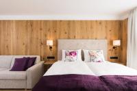 Ein Bett oder Betten in einem Zimmer der Unterkunft Boutiquehotel die Alpbacherin 4 Sterne Superior