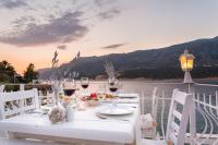 a white table with wine glasses and a view of the water at Club Çapa Hotel in Kas