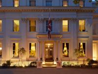 a white building with a flag in front of it at Malmaison Cheltenham in Cheltenham