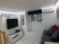 A television and/or entertainment centre at Cozy Apartment Malasaña FREE Parking