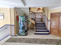 a staircase in a house with a door at Hotel Catalán Puerto Real in Puerto Real