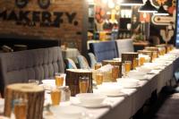 uma mesa comprida com pratos brancos e copos de cerveja em Willa ŻeglarSki em Kluszkowce