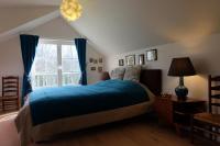 a bedroom with a blue bed and a window at B&amp;B Asbeek in Asse